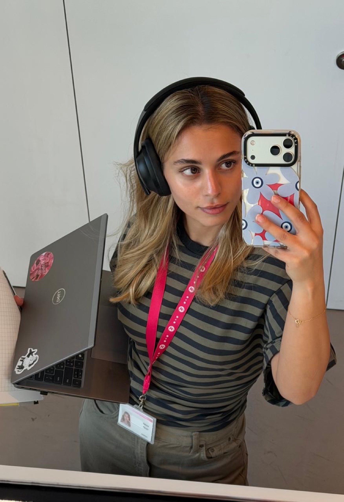 Mirror selfie with headphones, a laptop and a work lanyard