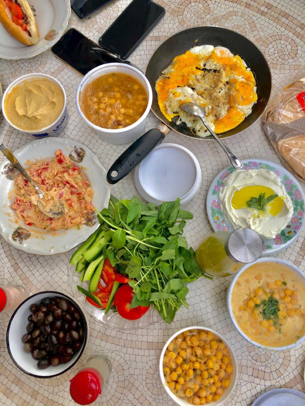 Lebanese breakfast spread with hummus, foul, labneh, eggs, olives and fresh vegetables